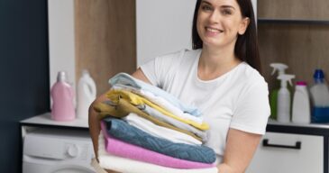 woman-holding-pile-clean-clothes